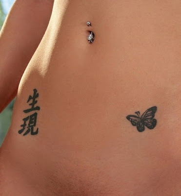 Calligraphy and butterfly stomach tattoo woman