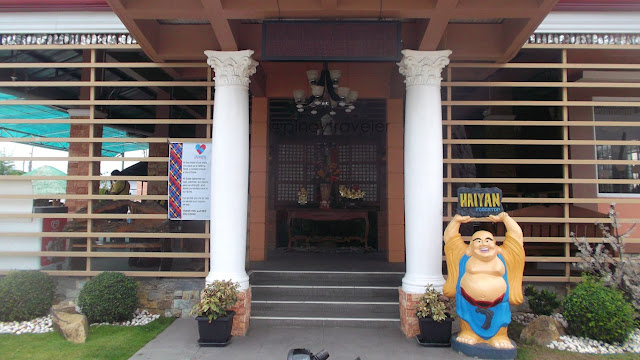 entrance of Haiyan foodstop with a jolly buddha image