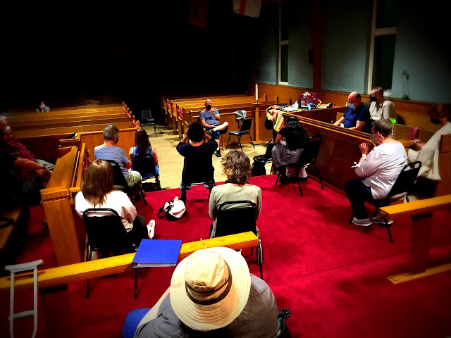 Masked and distanced Stairwell Carollers rehearsal