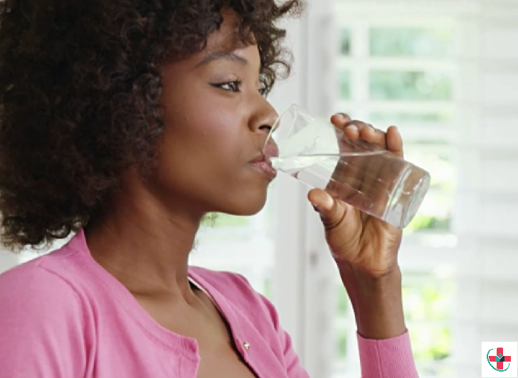 Woman drinking water after waking up