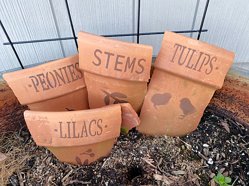 terra cotta markers in dirt