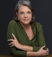 headshot photo of woman in a green top