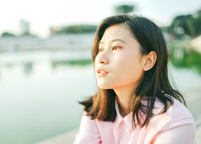 Young Asian woman sitting and thinking