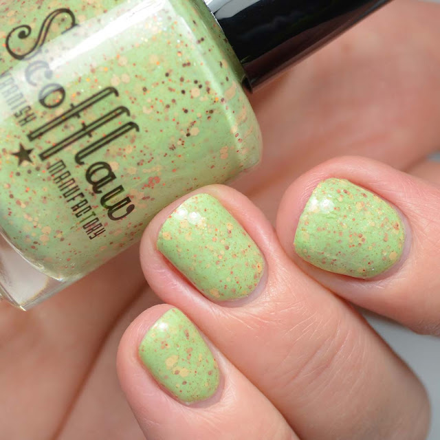 green nail polish with warm toned glitters swatch