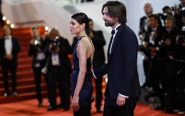 Charlotte Casiraghi wore a night blue v-neck and v-back silk satin evening gown by Chanel. Chanel diamond earrings