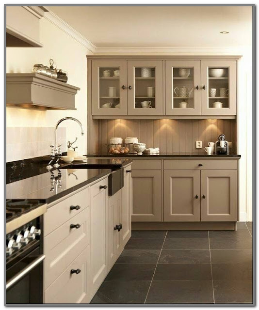 beige kitchen cabinets with black countertops