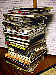 stack of compact discs on my desk ready for iPod insertion