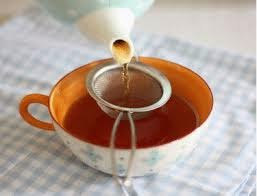 A cup of tropical tea made from boiled water, tea bags, sugar