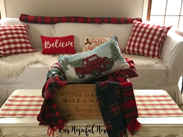 French crate with Christmas plaid scarves blankets