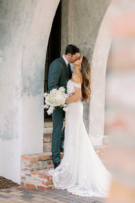 bride and groom kissing with white bouquet