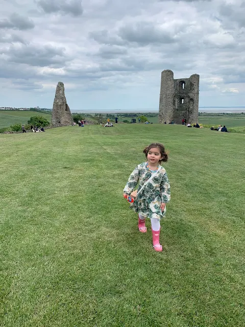 A preschooler running around with Hadleigh Castle ruins in the background