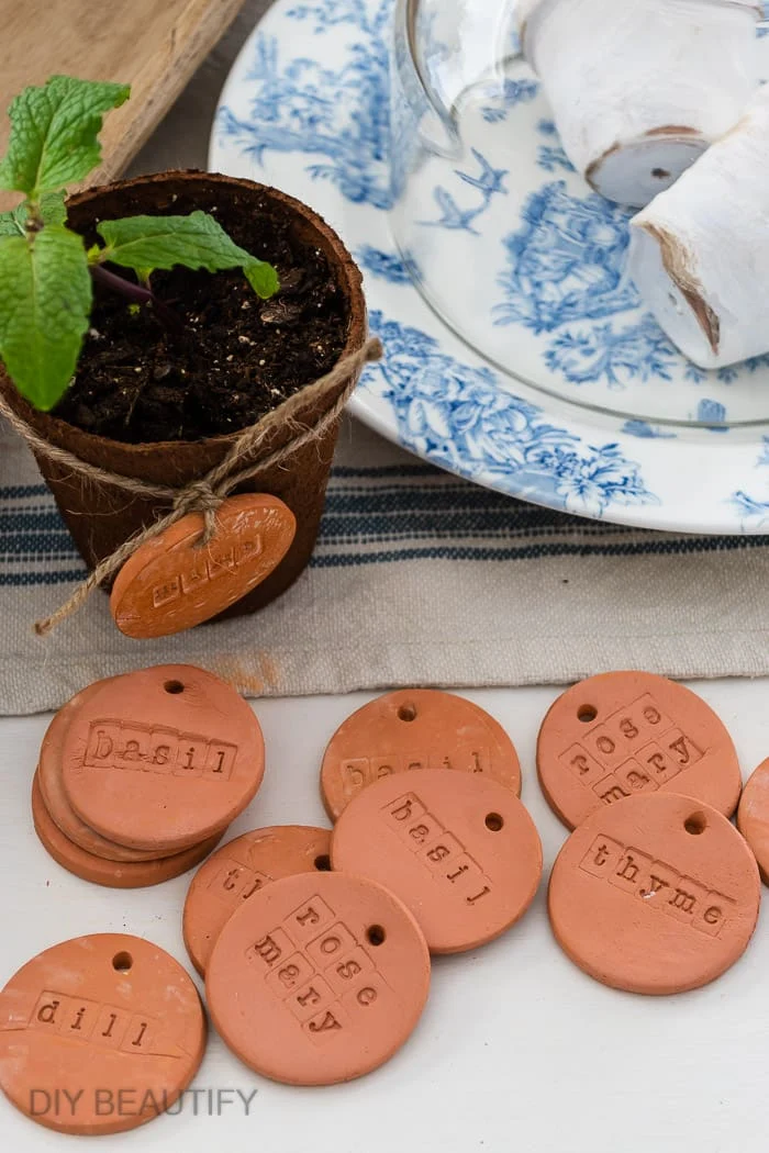 pile of clay herb markers with stamped words