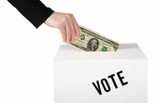 money being inserted in ballot box