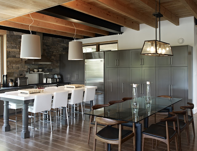 Photo of nice glassy dining table in the dining room by the kitchen inside of forest house