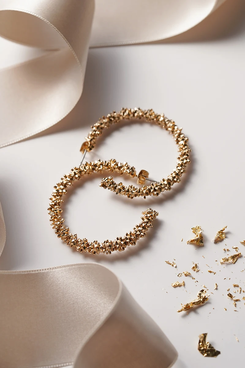 close-up of two circle earring on a white background