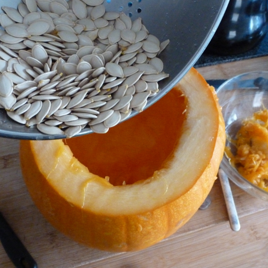 remove pumpkin seeds and insides of fruit to clean it out ready for carving