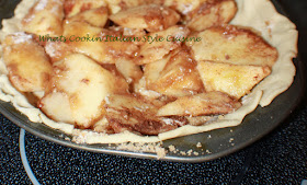 apples inside raw pie crust dough 