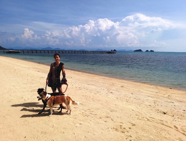 Anne with her dog on a Thailand beach