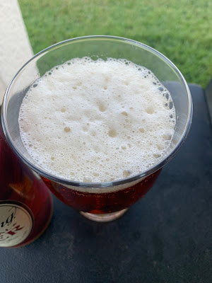A shot from the top of a Yuengling pint showing the high foam level