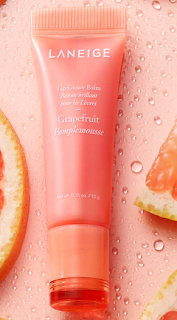 A close-up image of Laneige's Lip Glowy Balm against a soft, pastel background. The product is housed in a chic, cylindrical container with the Laneige logo prominently displayed. The balm itself appears creamy and luscious, promising to deliver intense hydration and a sheer tint for irresistible lips.