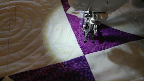 Modern Jacob's Ladder quilt using Island Batik fabrics and spiral walking foot quilting