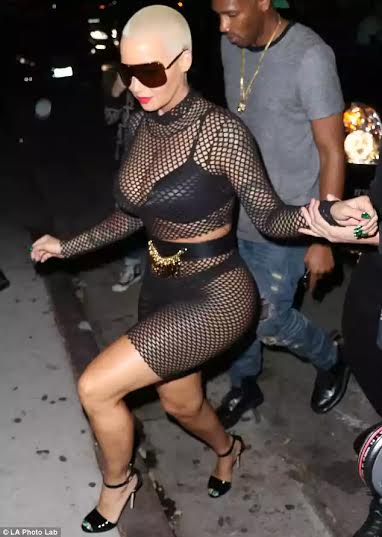 Amber Rose leaves little to the imagination in fishnet outfit