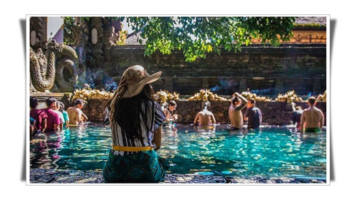 Ap picture of a lady Waiting for her turn at the entrance of The Holy Water Spring of Tirta Empul - Bali Male Escort Service