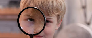 Kid with a magnifying glass