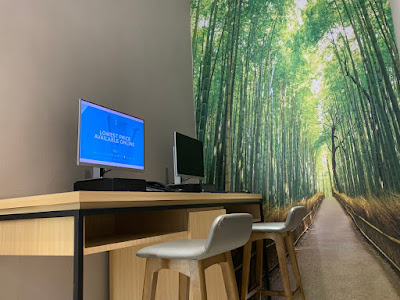 Business corner with computers, against backdrop of Arashiyama Bamboo Forest in Kyoto, Japan