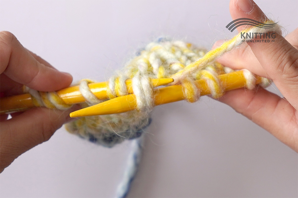 Insert LH needle into two stitches on RH needle.