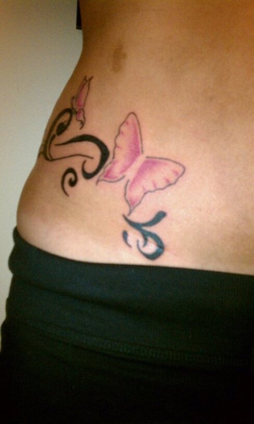 tattoo on girls side. Two butterflies on right side.