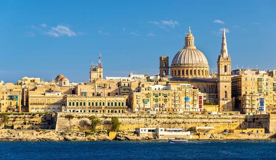 Malta’s capital city, Valletta, is a UNESCO World Heritage Site packed with history. Wander through its charming streets, visit St. John’s Co-Cathedral, and enjoy stunning views from the Upper Barrakka Gardens. Valletta’s rich history includes its role as the largest Royal Navy base in the Mediterranean during the British period.