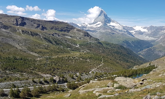 Findeln glacier valley with Grünsee is barely visible on the mountain slope across the valley. Grindjisee (lake with trees on its shore) could be seen on the right.