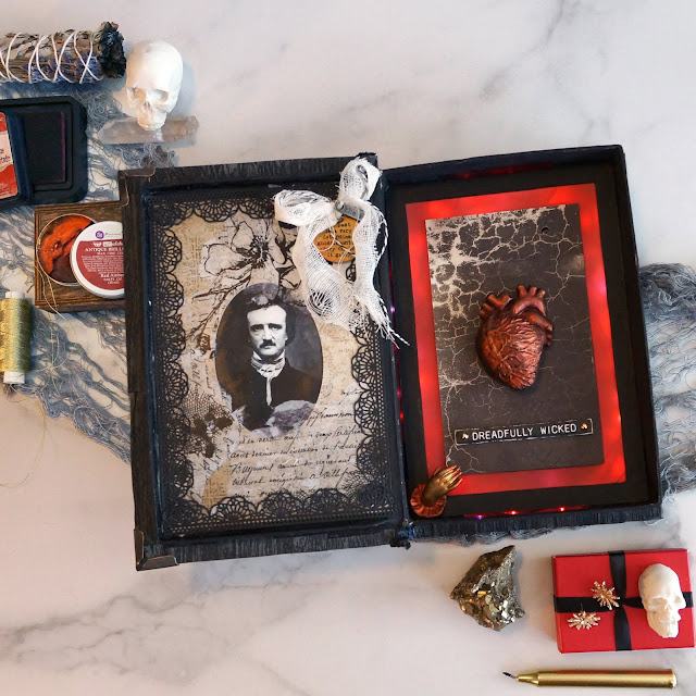 paper mâché book box Tell Tale Heart Edgar Allen Poe themed: Tim Holtz lumber 3D embossing folder, book corners, Halloween collage paper, materialize paper, abandoned paper, crochet die cuts, mummy cloth, trim, distress ink, quote token, story sticks, chipboard; Relics and Artifacts heart vessel resin; Finnabair art alchemy waxes; sound activated lights, gesso