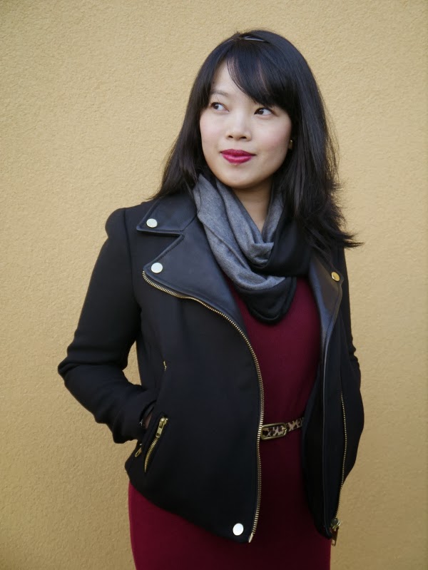 Vancouver blogger Lisa Wong of Solo Lisa wears a black moto jacket, black/grey colourblocked jersey scarf, burgundy sweater dress, and leopard print belt.