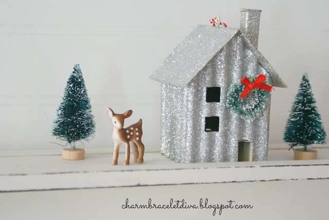 Darling miniature deer beside glittered house and bottle brush tree