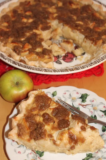 Slice of Sour Cream Apple Pie next to the finished pie.
