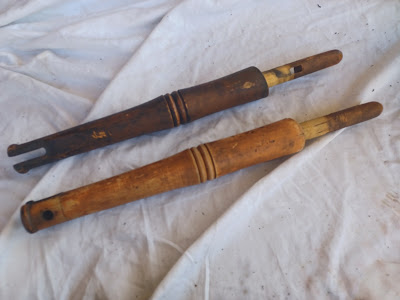 the wheel posts-- top one is still filthy, bottom one has been scoured so you can see the scuffed brown/yellow paint