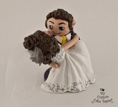 groom sweeping bride off her feet wedding cake topper