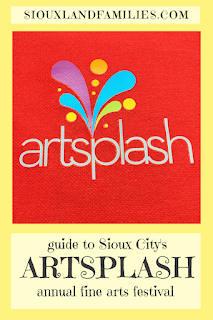 a plume of neon colors splashes up from the word "artsplash" in white on a red tote bag from the 2022 Sioux City ArtSplash festival