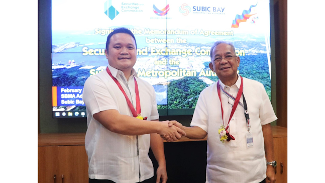 SEC commissioner Karlo S. Bello and SBMA chairman and administrator Eduardo Jose L. Aliño seal MOA with a handshake.