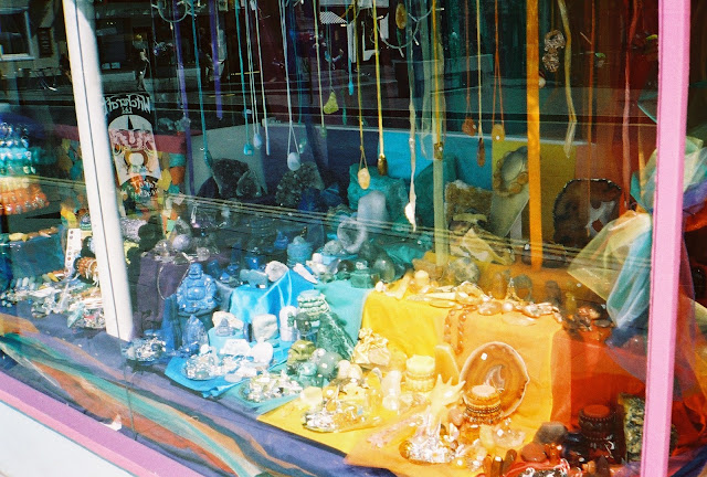 A shop window full of items arranged in a wide rainbow.