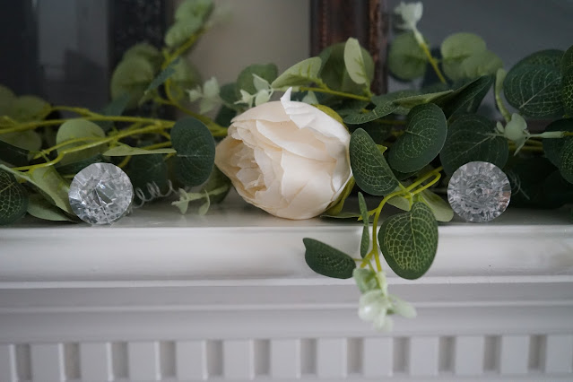 Rose garland with diamonds on mantel