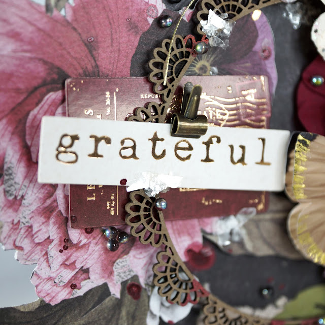 Grateful Mixed Media Altered Art: Prima Marketing midnight garden, paper flowers, Pretty Pale butterfly; Tim Holtz distress mica flakes, Idea-ology tiny clips; Reneabouquets designer glass beads fairy opal