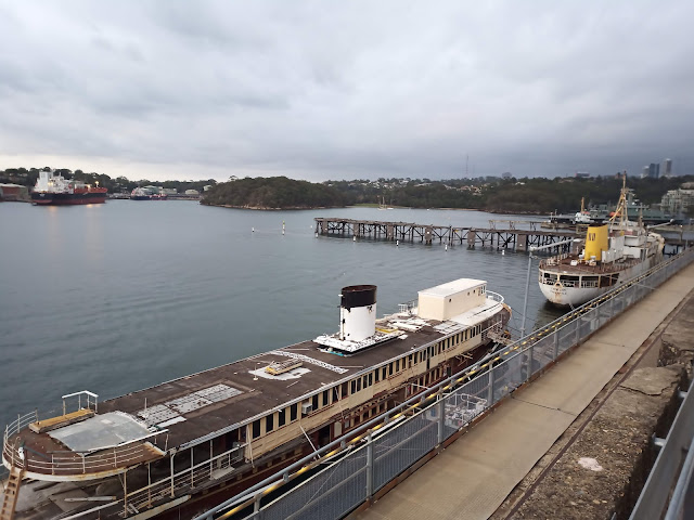 Historic boats and old wharf in the harbour