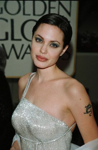 Beautiful Angelina Jolie with tribal arm dragon tattoo