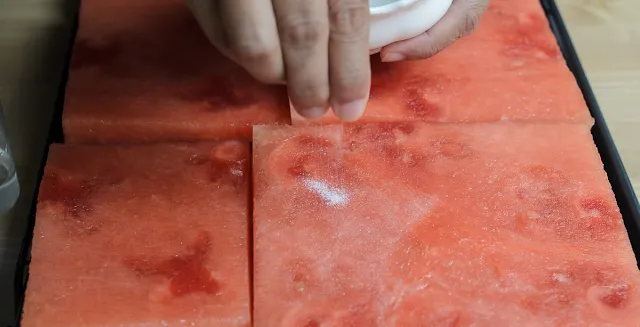 sprinkling sugar on watermelon for Watermelon and Strawberry Cake image