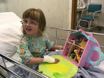 Jessica sitting on her theatre trolley ready to go in for her op