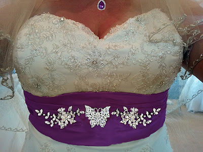 The brides wedding dress with butterflies and her