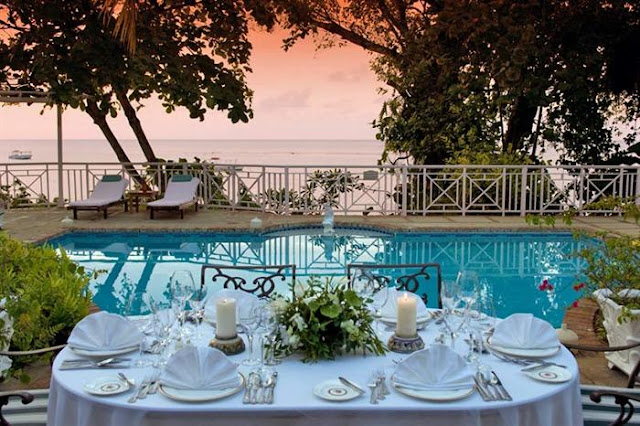 Photo of outdoor dinning table by the pool with amazing view